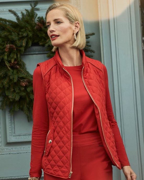 Red slim quilted vest by Chico's with matching colored fine sweater and trousers.